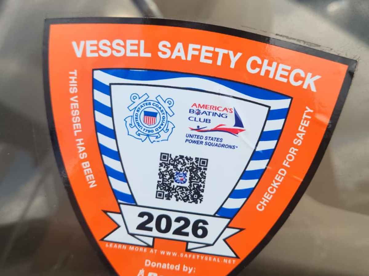 Vessel Safety Check sticker on a boat windshield, valid until 2026.