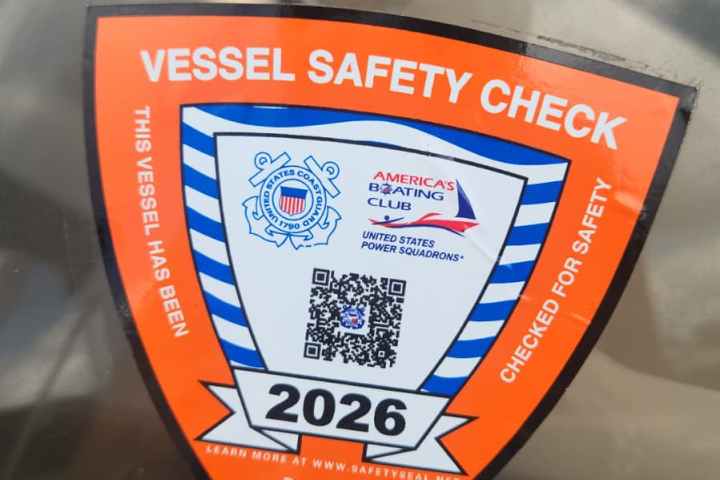 Vessel Safety Check sticker on a boat windshield, valid until 2026.