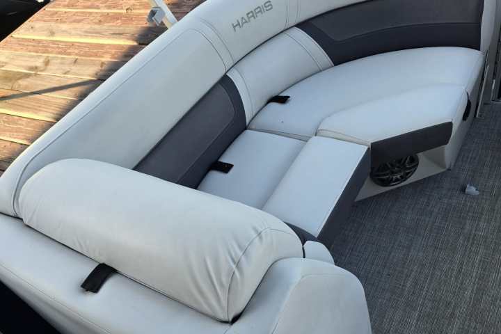White and gray boat seating with rectangular cushions on a deck.