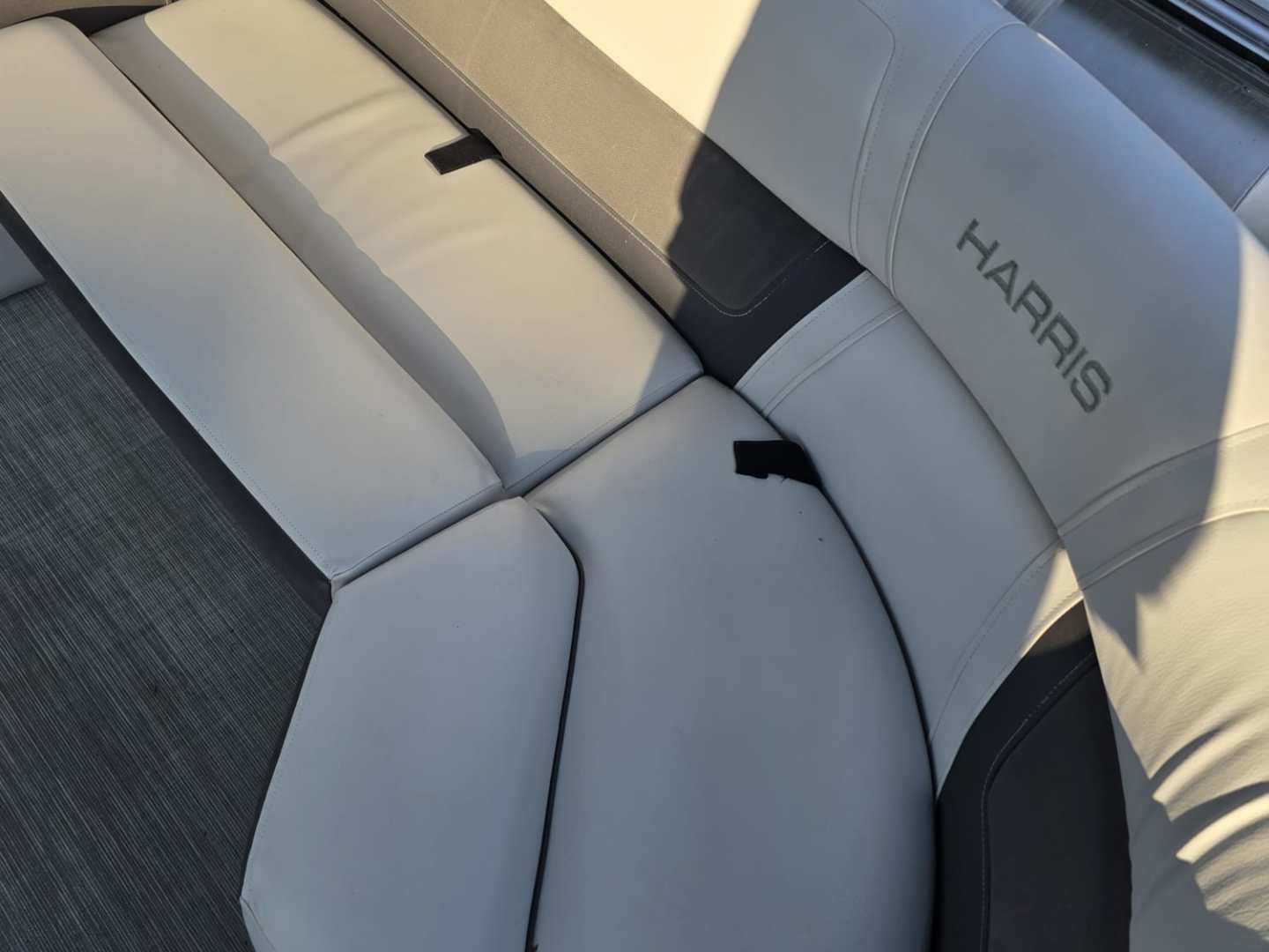 Light gray and dark gray boat seating with sunlight and shadow.