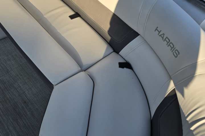 Light gray and dark gray boat seating with sunlight and shadow.