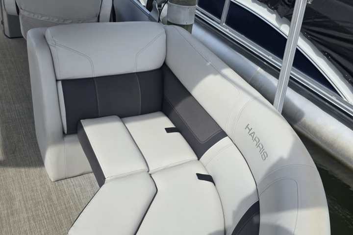 White and gray boat seating on a docked pontoon boat.